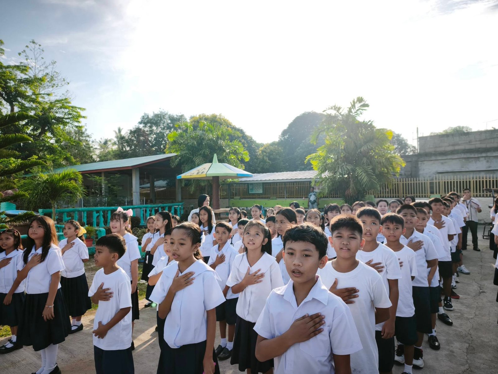 Pupils reciting the Panatang Makabayan at the school campus